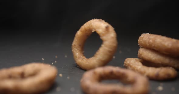 Onion rings close up slow motion studio, tasty fast food