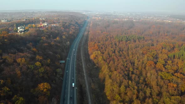 Countryside Road Through the Wood in Autumn