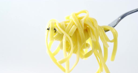 Close-up of cooked pasta on fork