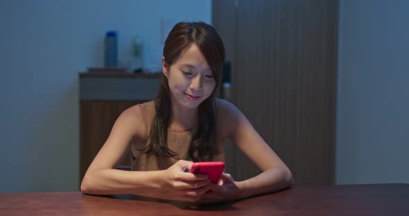 Woman check on mobile phone at night