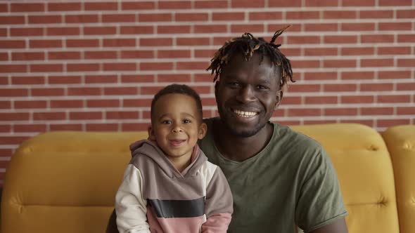 Mixed Race Family Dad Child Boy Happy Faces Sit on Sofa Bonding Closeup Portrait