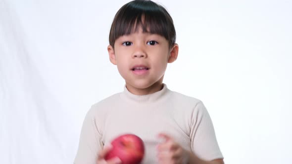 Happy little girl with apple.