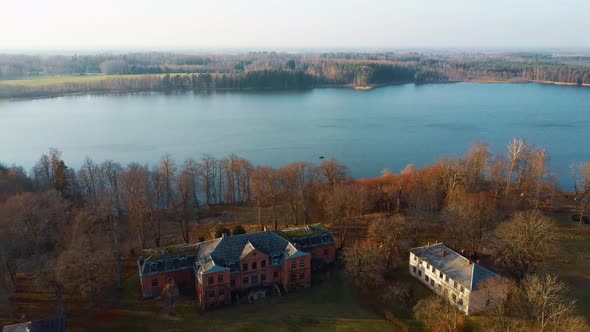 Old Red Brick House, Katvari Manor in Latvia and Katvaru Lake in the Background. Aerial Dron Shot 4K