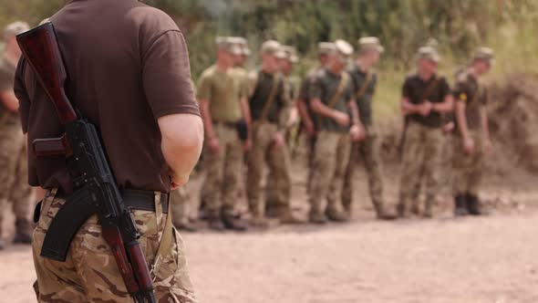 Soldiers Stand at the Checkpoint Behind Their Backs and Carrying Kalashnikov Assault Rifles