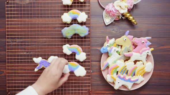 Unicorn cookies decorated with royal icing drying on drying rack.