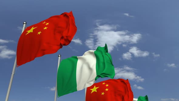 Flags of Nigeria and China Against Blue Sky alt