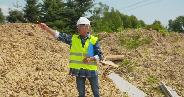 Male Engineer Explaining While Holding Blueprint