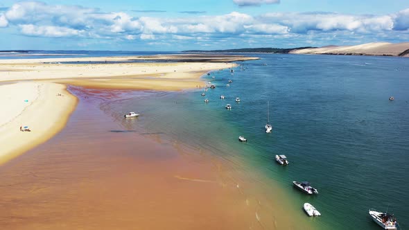 Banc d'Arguin in Arcachon Bay France with boats lined up along the sandbar, Aerial flyover view
