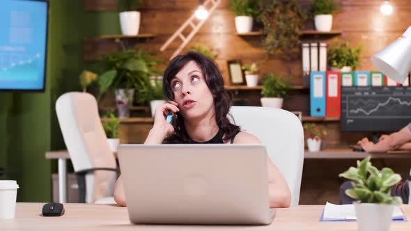 Happy Laughing Businesswoman Talks on the Phone