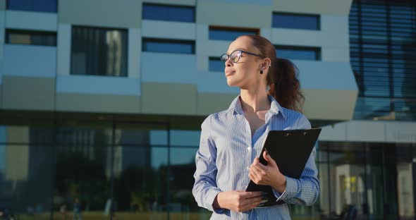 A Businesswoman is Walking Near the Business Center