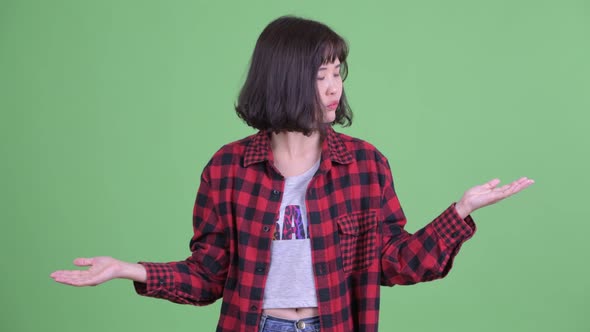 Confused Asian Hipster Woman Comparing Something