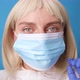 Young Female Doctor or Nurse in Protective Suit Medical Mask Gloves Putting Mask on Her Face for - VideoHive Item for Sale