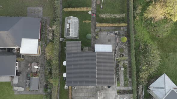 Drone Rising Over Lone Man Walking From House