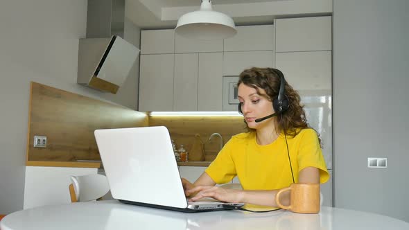 Young Woman is Having Online Meeting Using Her Laptop Businesswoman with Digital Tablet Sitting on