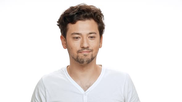 Young Handsome Man Smiling Beckoning Looking at Camera Over White Background