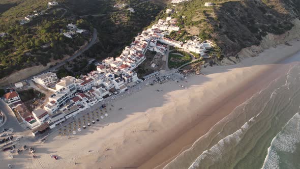 Aerial perspective of idyllic Praia da Salema beach in Algarve Portugal.