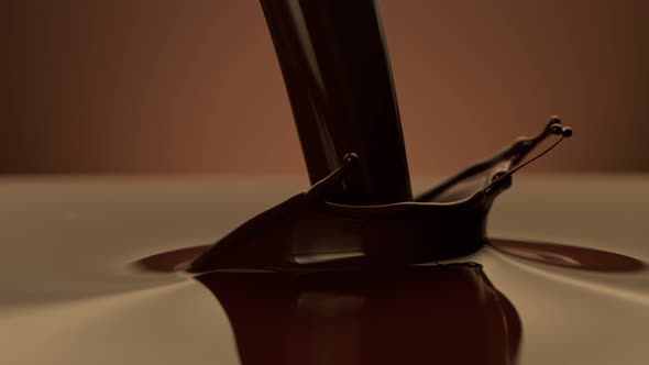 Super Slow Motion Shot of Pouring Melted Chocolate on Brown Gradient Background at 1000 Fps