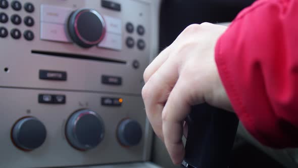 Man Hand Controls a Manual Gearbox