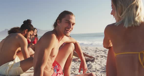 Friends talking and laughing at beach