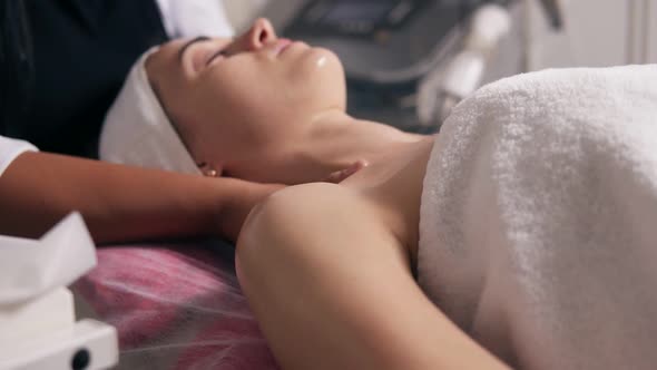 Closeup View of a Woman with Her Eyes Closed Lying on the Couch During Cosmetic Face Procedure