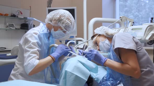 People health and dental care, woman at work as dentist with assistant and visiting young woman 