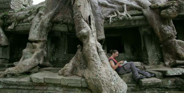 Young Man Reading Book In Angkor