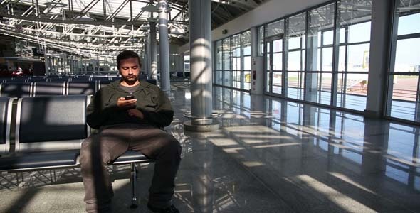 Man Using Mobile Phone At Airport 2