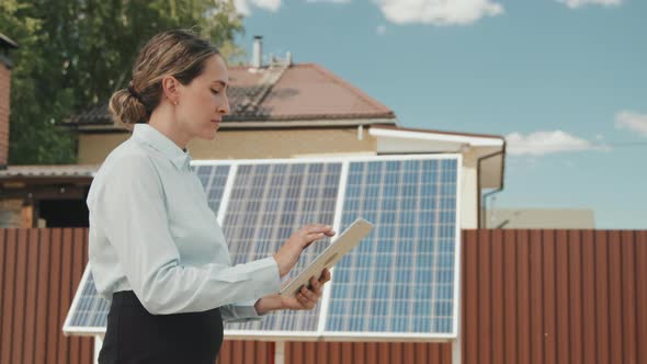 Woman Turning On Solar Panels