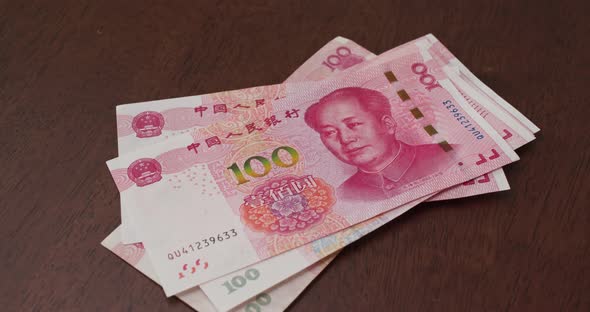 Counting chinese RMB banknote on the table