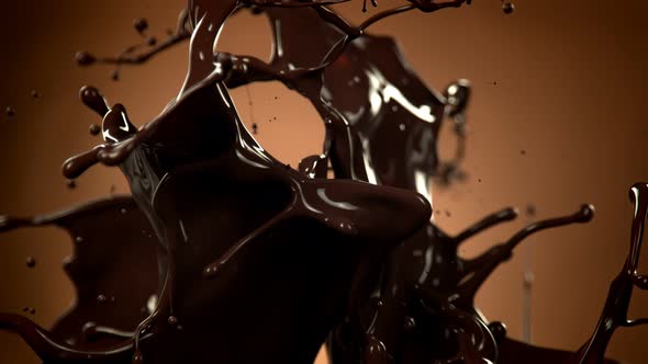 Super Slow Motion Shot of Splashing Melted Chocolate on Brown Gradient Background at 1000 Fps