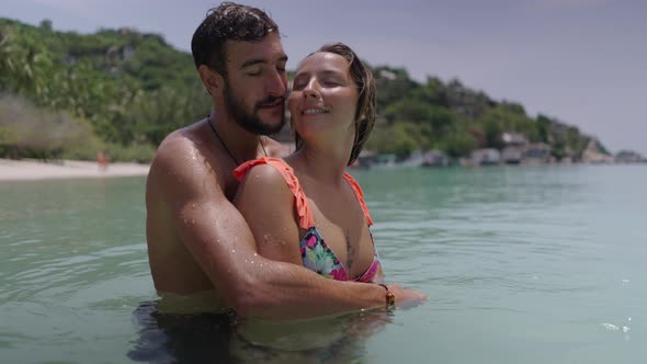 A Close Up Shot of an Attractive Couple Cuddling in the Water