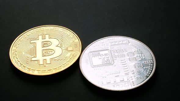Golden and Silver Bitcoin Coins on Black