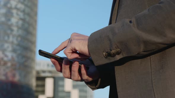 Businessman Hands Using Smartphone on Street. Employee Typing Message on Phone