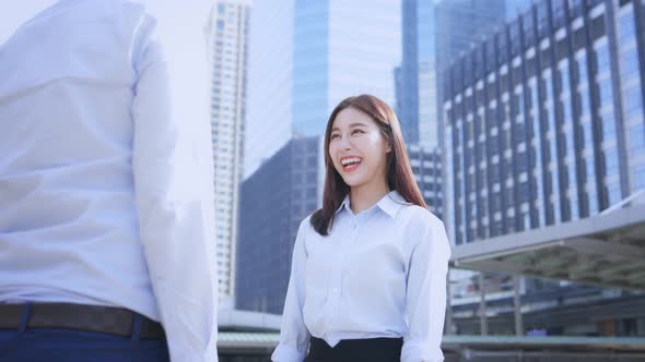 Businesswoman Shaking Hands with Man