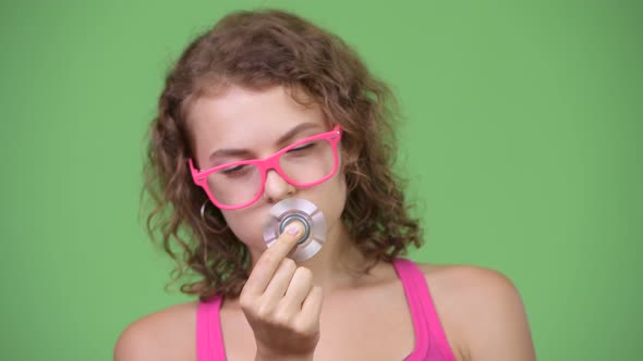 Young Beautiful Nerd Woman Playing with Fidget Spinner and Looking Amazed