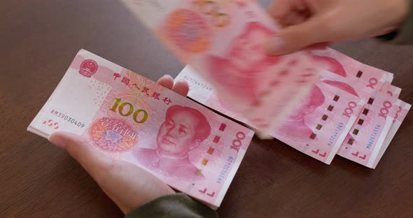 Woman counting RMB banknote