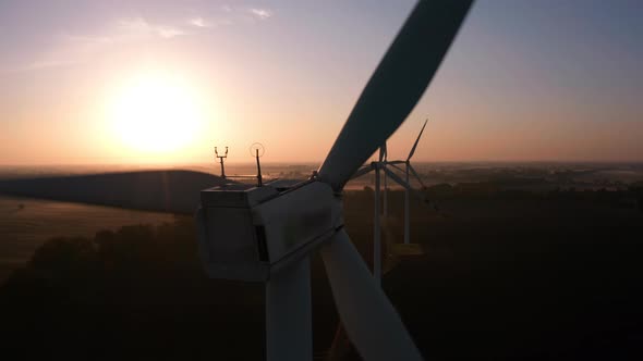 Large Wind Turbines at Sunrise with Fog Aerial View