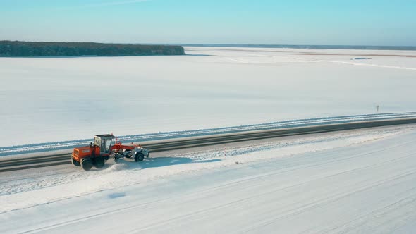 Aerial View Snow Removal Tractor Clears Road From Snow