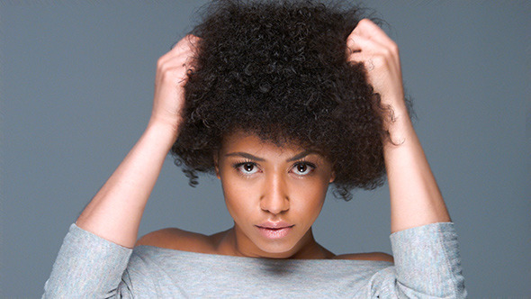 Beautiful Woman Clutching Her Afro Hairstyle