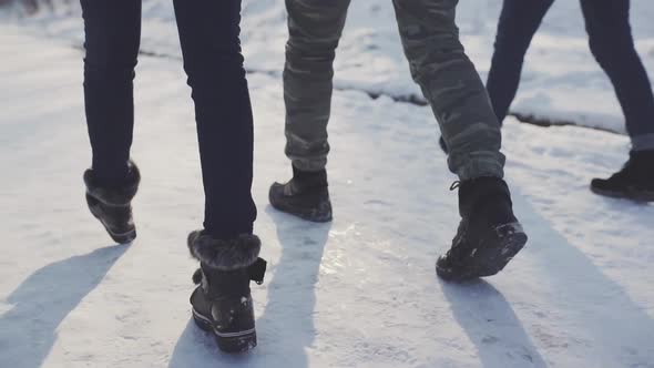 Feet Walking in the Snow with Tracking Shoes