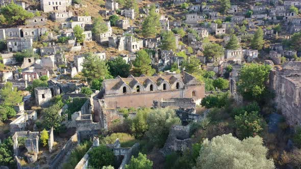 aerial drone circling onto an abandoned greek orthodox church in the ghost town village of Kayakoy i