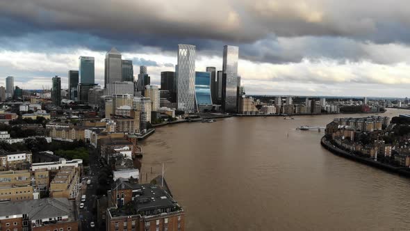 Aerial view of stormy dark clouds over Canary Wharf, approaching London financial District