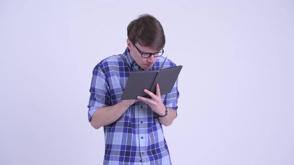 Shy Young Hipster Man Covering Face with Book