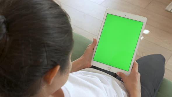 Young Indian Woman Using Digital Tablet with Green screen on Sofa, Mock up, Entertainment