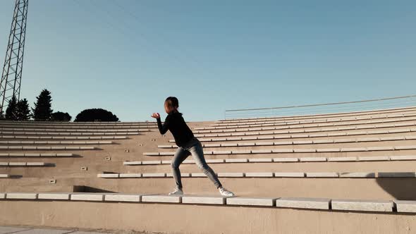 Young girl dances in an outdoor theater