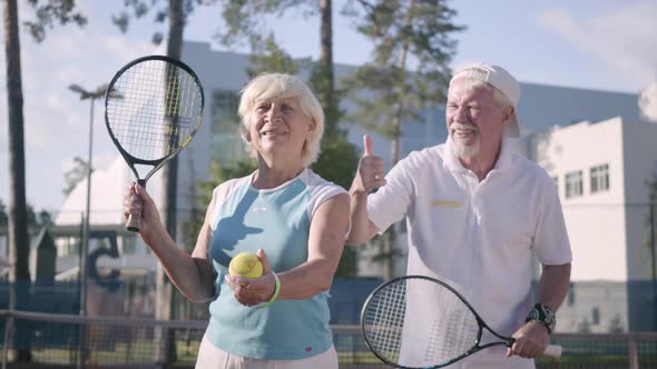 Portrait Happy Adult Couple Playing Tennis on a Sunny Day