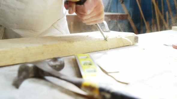 Carpenter working on his craft and smiling for camera