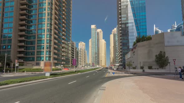 Dubai Marina with Skyscrapers Timelapse Hyperlapse and Traffic on the Street Near Concrete Road