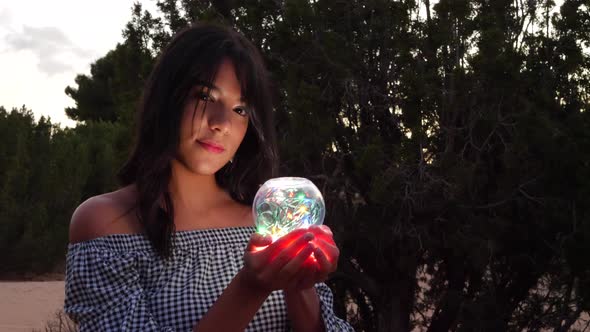 A mysterious fortune teller with a magic crystal ball glowing in a fantasy land.