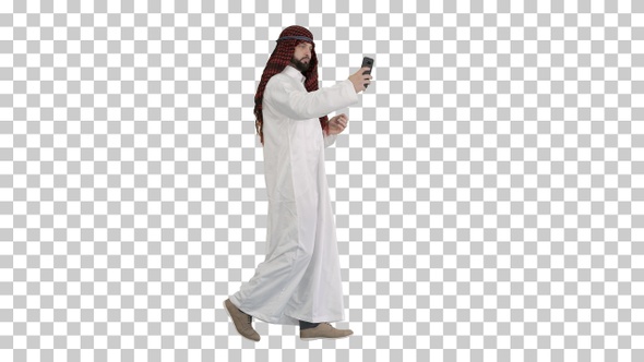 Arabian man walking and making a selfie, Alpha Channel